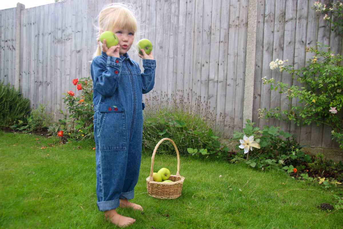 Kids vintage-inspired denim jumpsuit with cherry embroidery and zipper front, retro wash toddler girl boiler suit for ages 1 to 5.