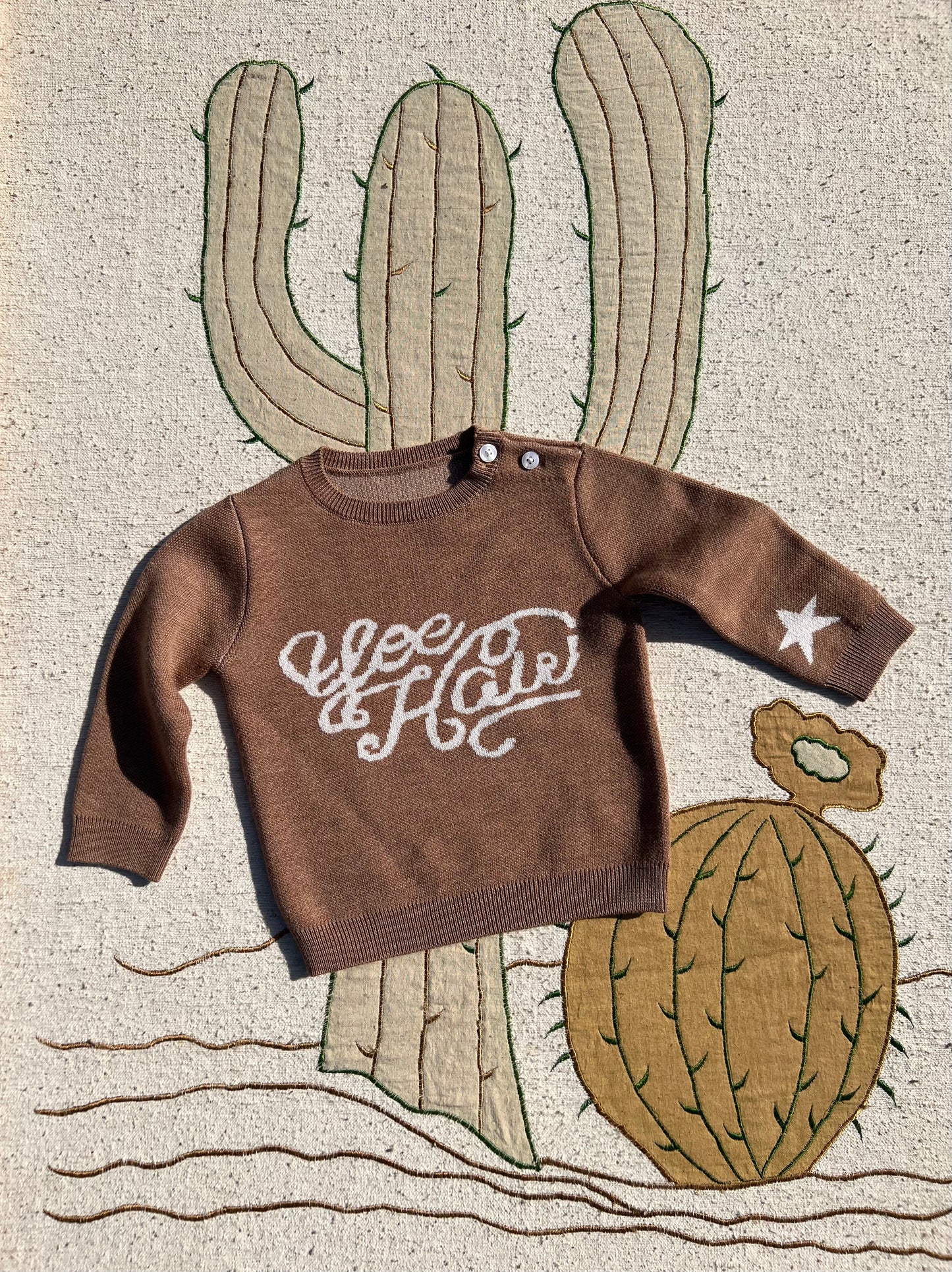 Brown kids’ merino wool knitted jumper with playful yeehaw cowboy design