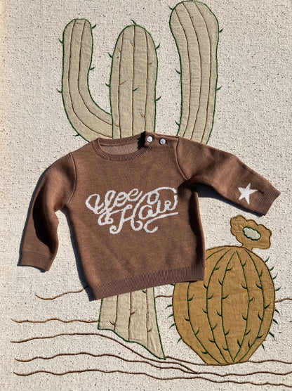 Brown kids’ merino wool knitted jumper with playful yeehaw cowboy design