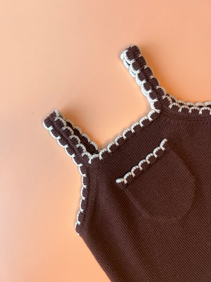 Children’s brown merino wool dungarees with adjustable straps and white scallop detail.