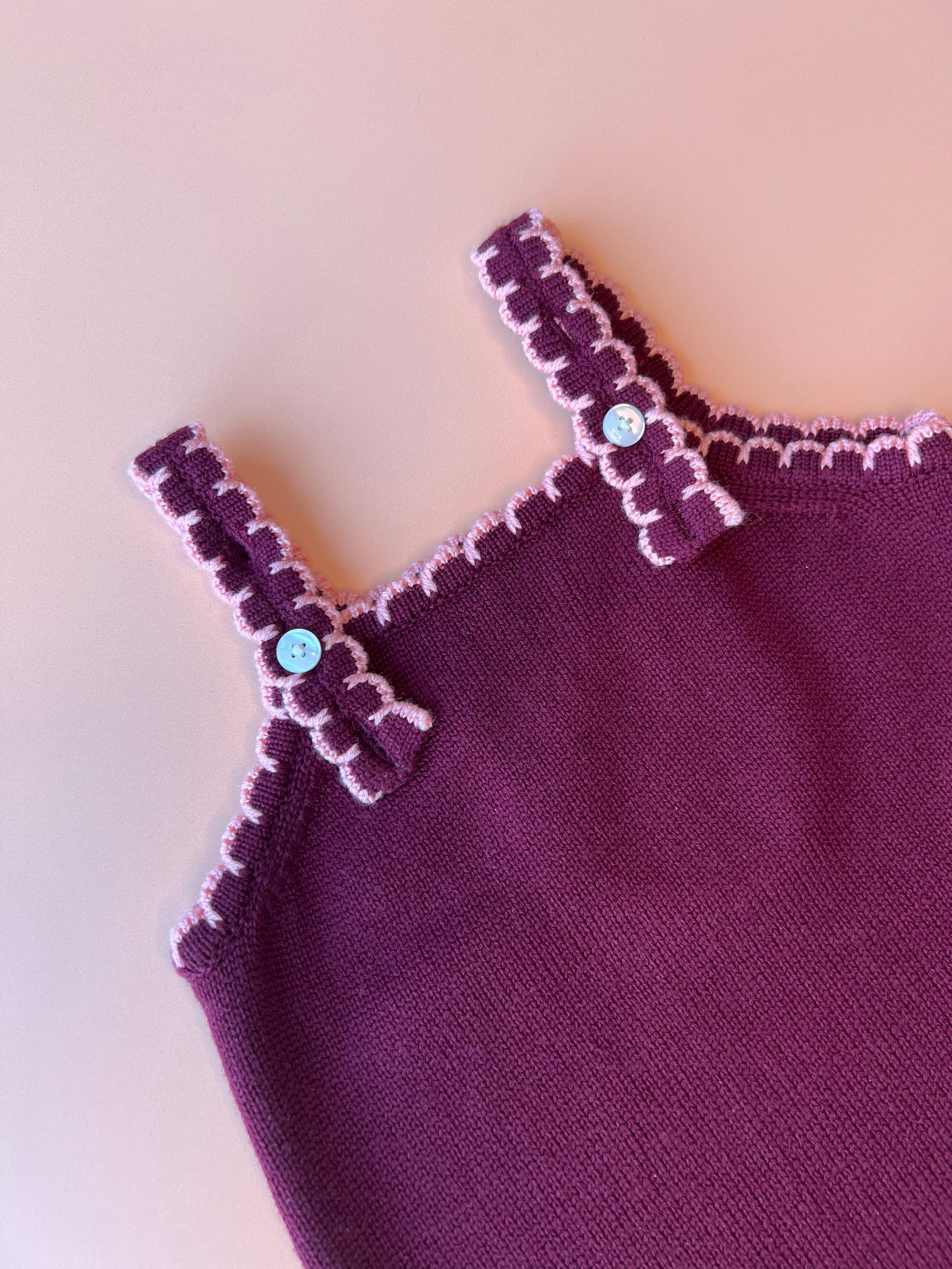 Soft plum merino wool dungarees for children with pink scallop design and adjustable fit