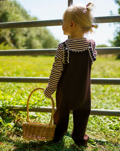 Brown merino wool kids’ dungarees featuring adjustable straps and white scallop trim