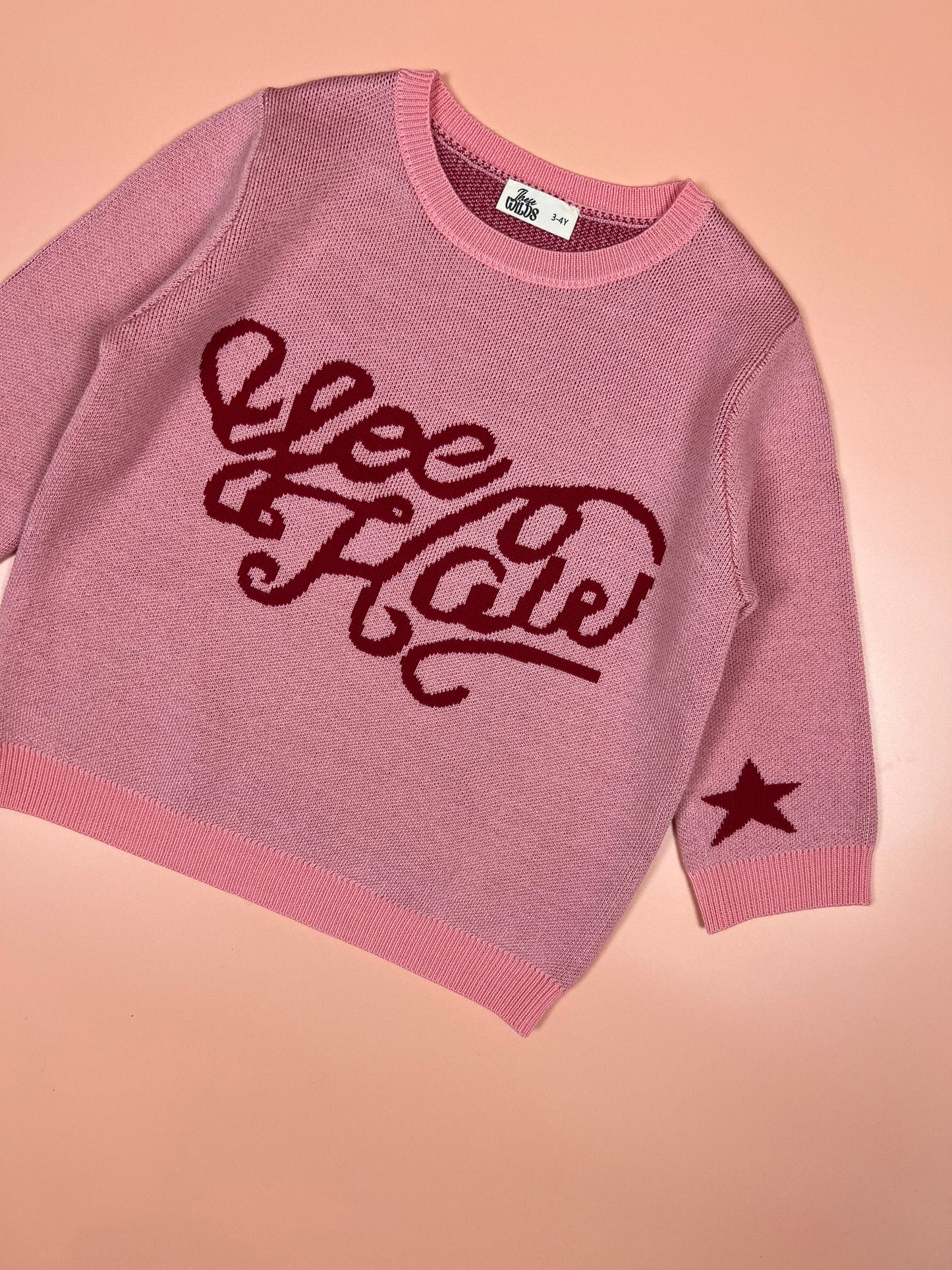 Pink kids merino wool knitted jumper with playful yeehaw cowboy design