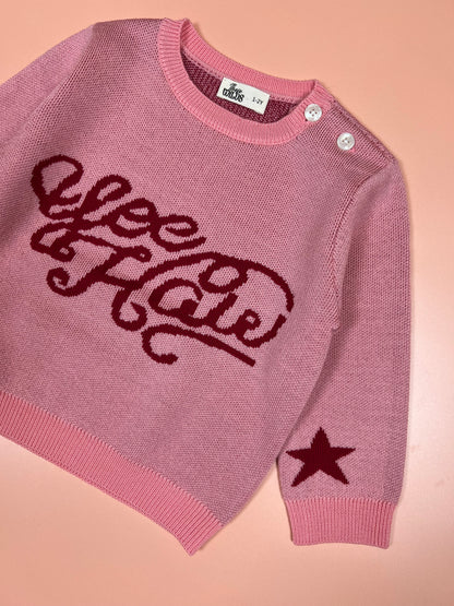 Pink knitted kids’ merino wool sweater with western-themed yeehaw graphic.