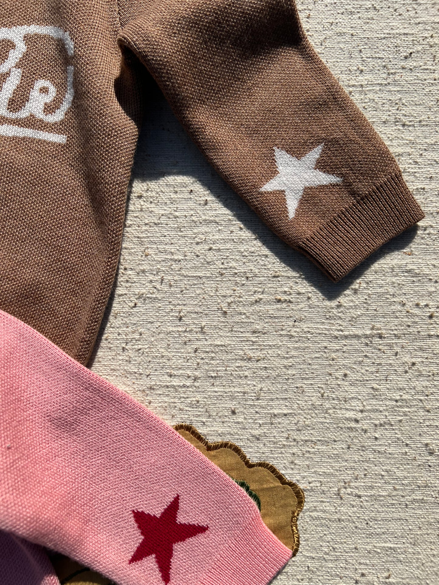 kids Brown and pink jumpers with star designs 