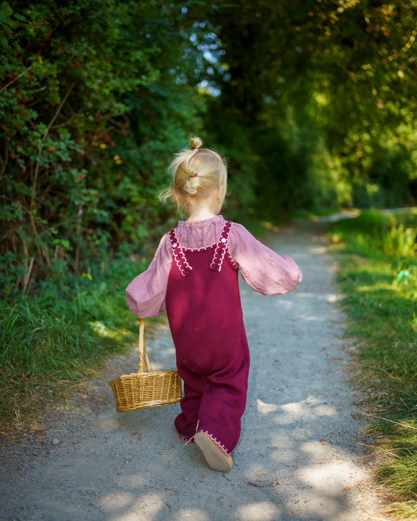 Children’s knitted plum merino wool dungarees with delicate pink scallop edging